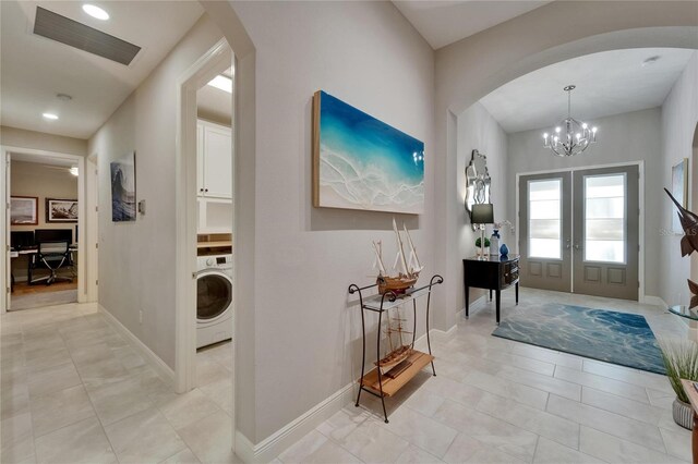 6507 Maiden Sea Dr, Apollo Beach, FL 33572 - entrance foyer with an inviting chandelier, arched walkways, french doors, washer / dryer, and visible vents