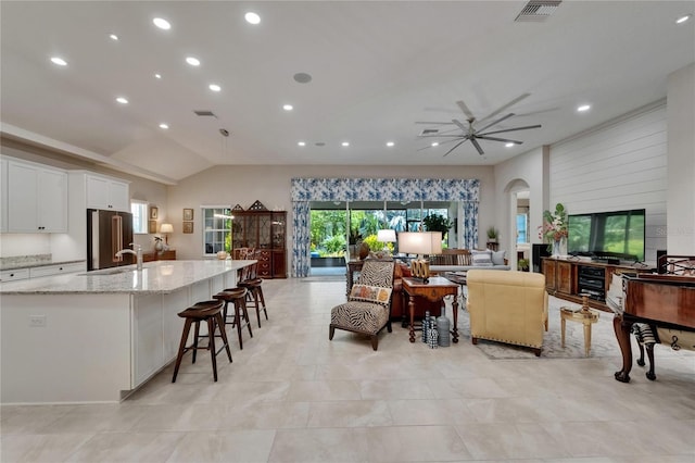 6507 Maiden Sea Dr, Apollo Beach, FL 33572 - living room featuring visible vents, arched walkways, lofted ceiling, and recessed lighting