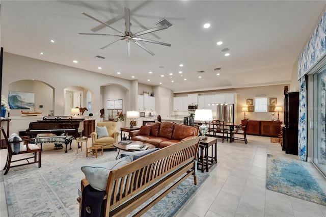 6507 Maiden Sea Dr, Apollo Beach, FL 33572 - living room with ceiling fan, visible vents, arched walkways, light tile patterned floors, and recessed lighting