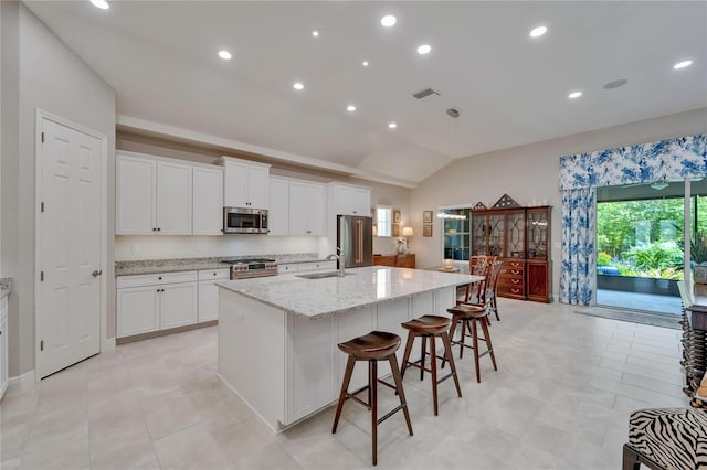 6507 Maiden Sea Dr, Apollo Beach, FL 33572 - kitchen featuring visible vents, lofted ceiling, an island with sink, a sink, and premium appliances