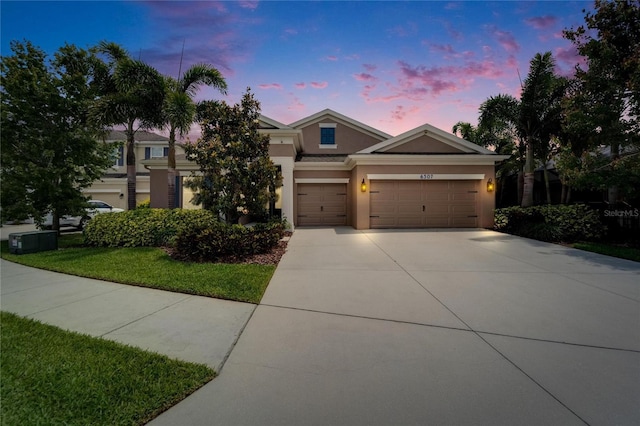 6507 Maiden Sea Dr, Apollo Beach, FL 33572 - view of front facade featuring an attached garage, stucco siding, a yard, and concrete driveway