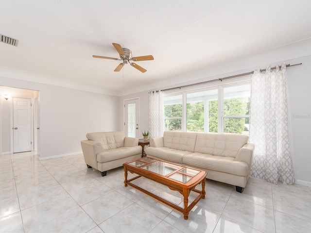 living area featuring light tile patterned floors, baseboards, ceiling fan, and visible vents