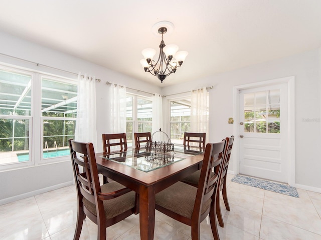 dining room featuring baseboards, an inviting chandelier, and light tile patterned floors