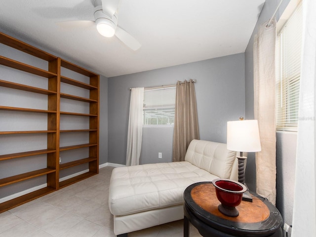bedroom with baseboards, a ceiling fan, and light tile patterned flooring