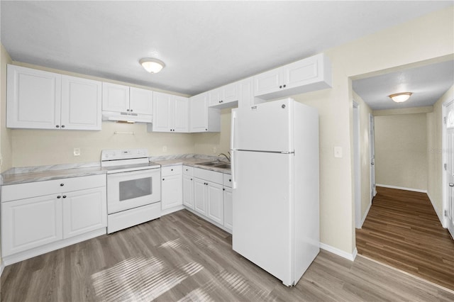 kitchen with a sink, white cabinets, white appliances, under cabinet range hood, and light wood-style floors