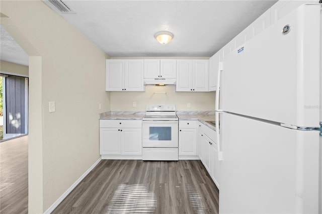 kitchen with white appliances, wood finished floors, under cabinet range hood, light countertops, and baseboards