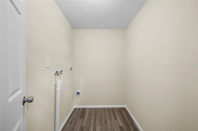 clothes washing area with laundry area, washer hookup, baseboards, and dark wood-type flooring