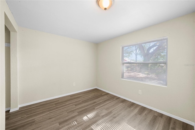 empty room with wood finished floors and baseboards