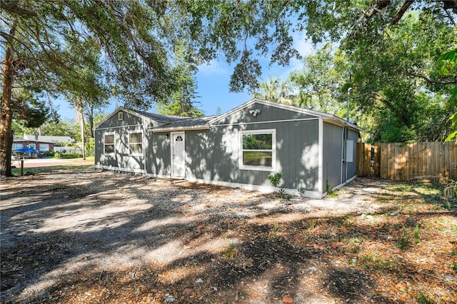 exterior space featuring a garage and fence