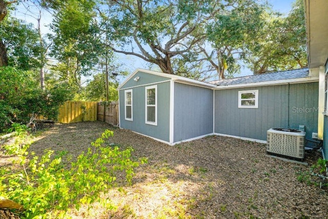 exterior space with central air condition unit and fence