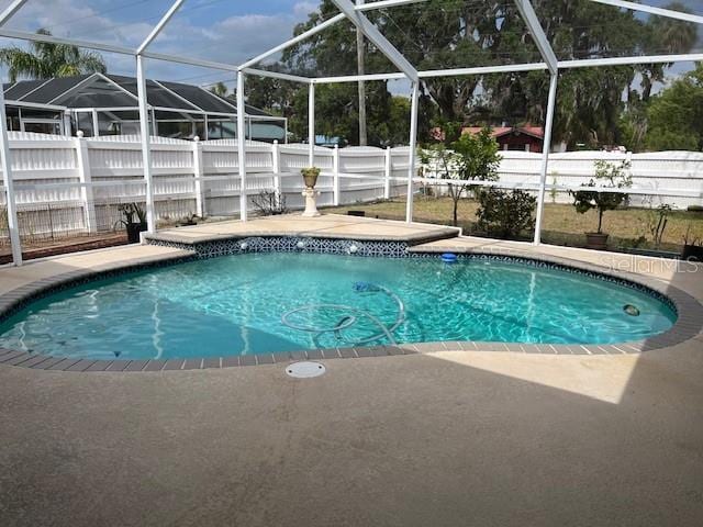 view of pool with a fenced in pool, a fenced backyard, a lanai, and a patio