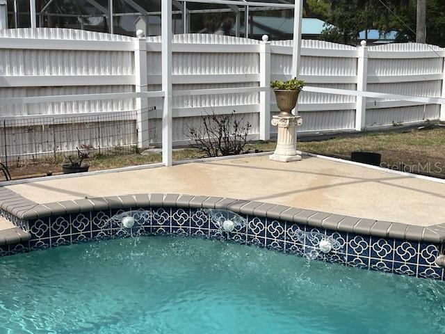 view of swimming pool with a fenced in pool and fence
