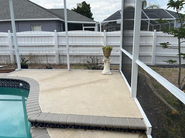 view of patio featuring a fenced in pool and fence