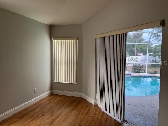 interior space with baseboards and wood finished floors