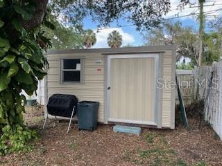 view of shed with fence