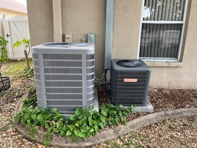 details featuring stucco siding and cooling unit