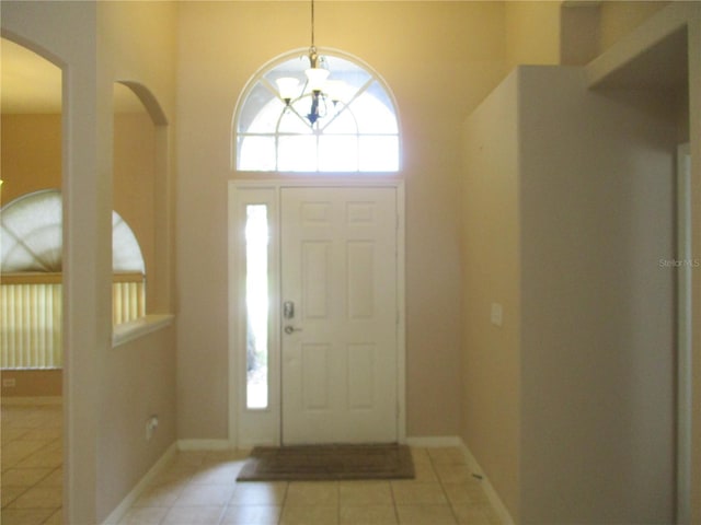 2213 Towering Oaks Cir, Seffner, FL 33584 - entryway featuring a chandelier, arched walkways, and light tile patterned floors