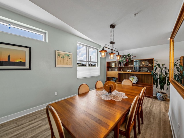 dining area featuring wood finished floors and baseboards