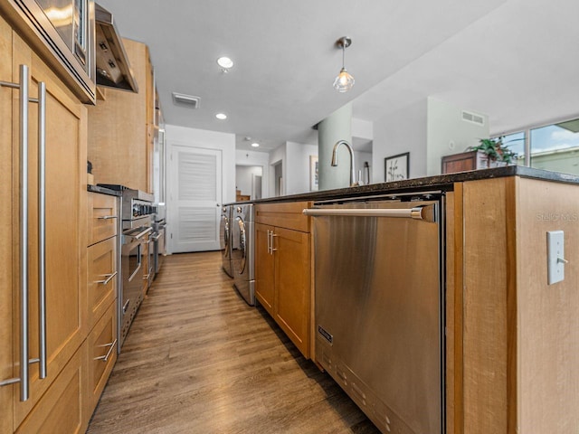 kitchen with dishwasher, light wood-style flooring, dark countertops, washer / clothes dryer, and recessed lighting