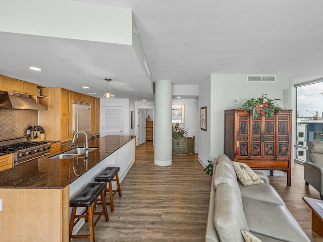 living area featuring wood finished floors, baseboards, and recessed lighting
