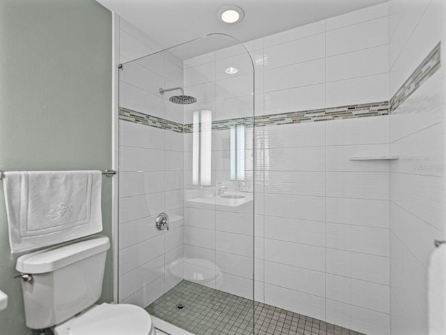 bathroom with toilet and a shower stall