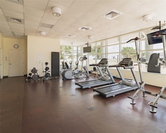 exercise room featuring a drop ceiling