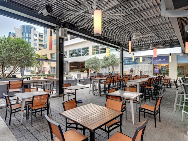 view of patio with outdoor dining space and a bar