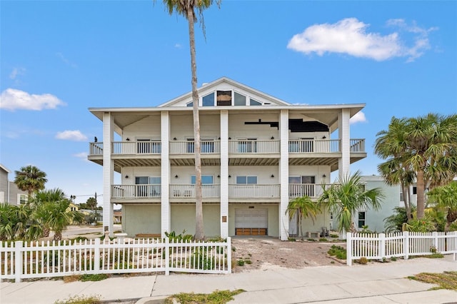 1104 Pass A Grille Way, St Pete Beach, FL 33706 - beach home with a garage, a fenced front yard, a balcony, and driveway