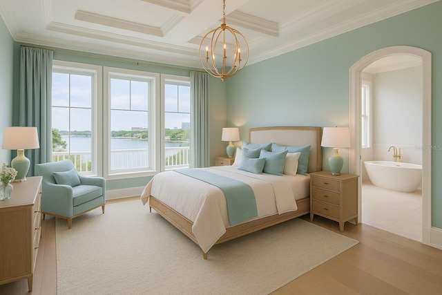 1104 Pass A Grille Way, St Pete Beach, FL 33706 - bedroom with crown molding, a water view, a chandelier, arched walkways, and light wood finished floors