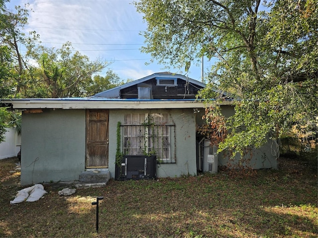 back of house with stucco siding