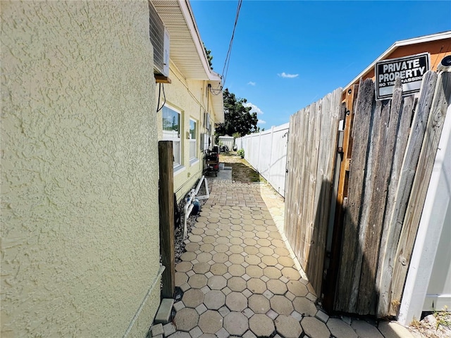 1101 Alcazar Way S, Saint Petersburg, FL 33705 - view of home's exterior with a fenced backyard and stucco siding