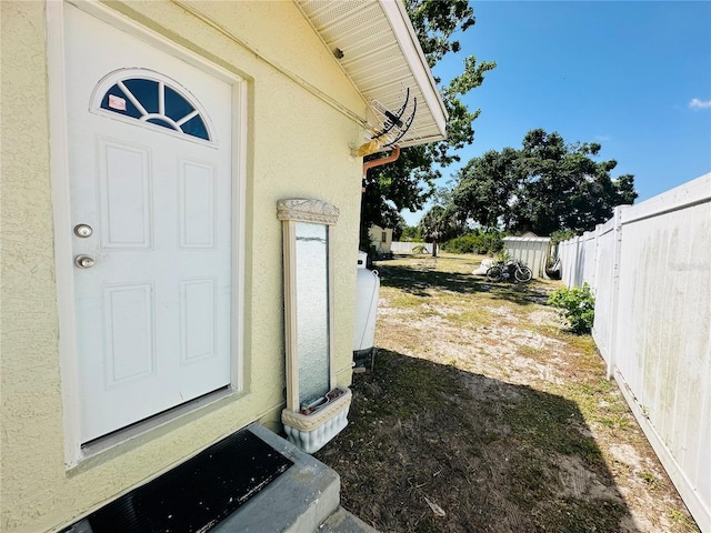 1101 Alcazar Way S, Saint Petersburg, FL 33705 - view of exterior entry featuring fence and stucco siding