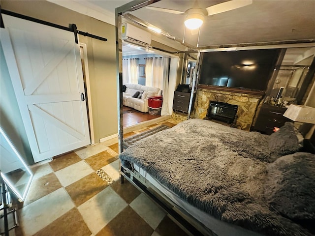 1101 Alcazar Way S, Saint Petersburg, FL 33705 - bedroom featuring a fireplace, tile patterned floors, a wall mounted AC, and a barn door