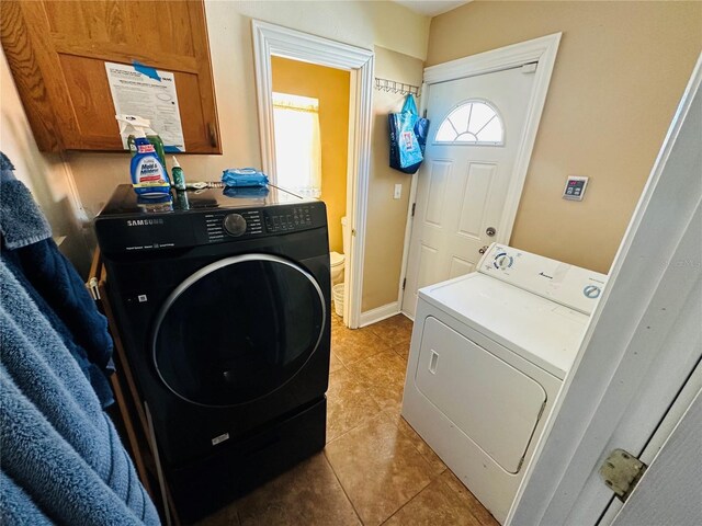 1101 Alcazar Way S, Saint Petersburg, FL 33705 - washroom featuring laundry area, washer and clothes dryer, and light tile patterned floors