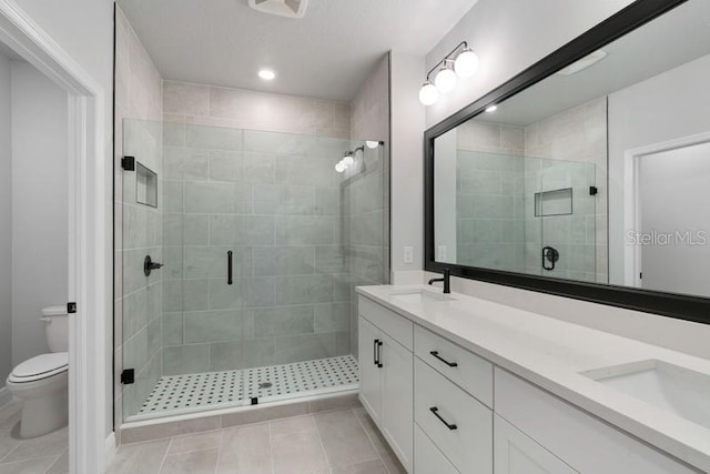406 N Westland St Unit 1, Tampa, FL 33609 - full bath featuring toilet, a stall shower, double vanity, and tile patterned floors