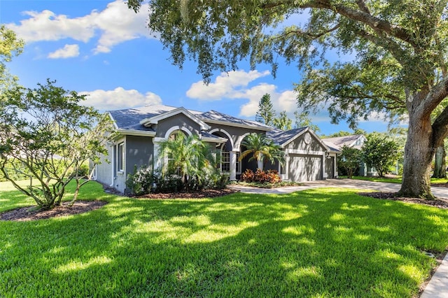 4690 Wrentham Pl, Palm Harbor, FL 34685 - view of front of house featuring a garage, driveway, a front yard, and stucco siding