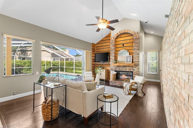 4690 Wrentham Pl, Palm Harbor, FL 34685 - living room with a sunroom, a ceiling fan, wood finished floors, high vaulted ceiling, and a brick fireplace