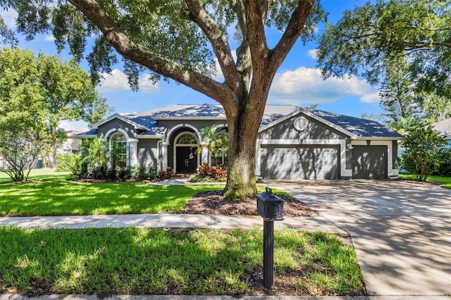 4690 Wrentham Pl, Palm Harbor, FL 34685 - view of front of home featuring concrete driveway, a garage, a front lawn, and stucco siding
