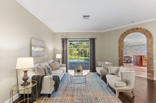 4690 Wrentham Pl, Palm Harbor, FL 34685 - living area featuring wood finished floors, arched walkways, and ornamental molding