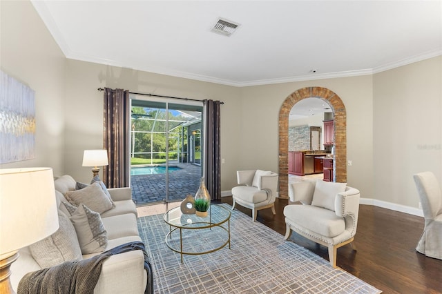 4690 Wrentham Pl, Palm Harbor, FL 34685 - living room featuring wood finished floors, ornamental molding, arched walkways, and a sunroom