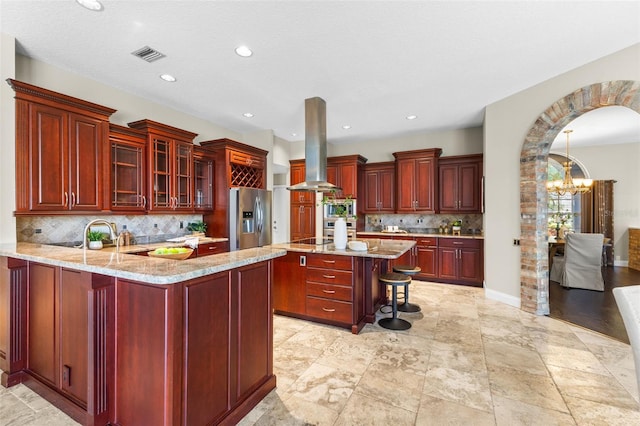 4690 Wrentham Pl, Palm Harbor, FL 34685 - kitchen with appliances with stainless steel finishes, dark brown cabinets, island exhaust hood, a chandelier, and recessed lighting