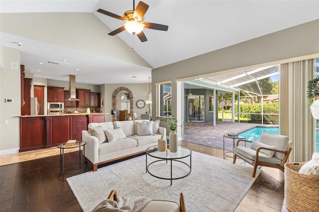 4690 Wrentham Pl, Palm Harbor, FL 34685 - living room featuring a sunroom, vaulted ceiling, a ceiling fan, wood finished floors, and recessed lighting