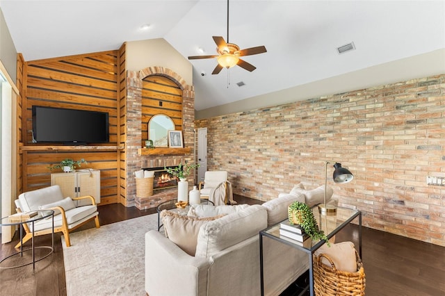 4690 Wrentham Pl, Palm Harbor, FL 34685 - living area with a ceiling fan, brick wall, wood finished floors, a brick fireplace, and high vaulted ceiling