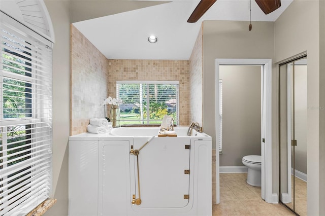 4690 Wrentham Pl, Palm Harbor, FL 34685 - bathroom with ceiling fan, a bath, and tile patterned floors