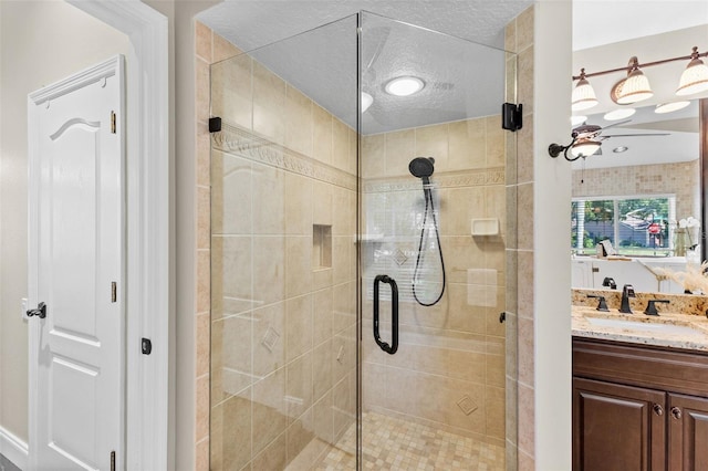4690 Wrentham Pl, Palm Harbor, FL 34685 - bathroom featuring a shower stall, vanity, and a textured ceiling