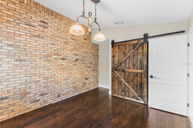 4690 Wrentham Pl, Palm Harbor, FL 34685 - empty room featuring brick wall, wood finished floors, and a barn door