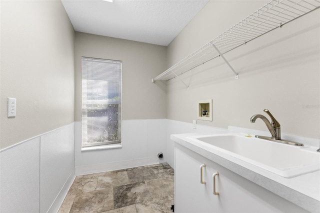 4690 Wrentham Pl, Palm Harbor, FL 34685 - washroom with washer hookup, cabinet space, stone finish flooring, and wainscoting