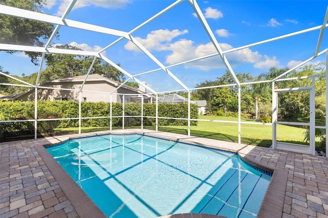 4690 Wrentham Pl, Palm Harbor, FL 34685 - outdoor pool featuring glass enclosure, a patio, and a yard