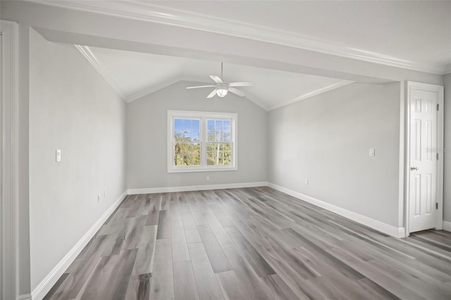 interior space featuring crown molding, baseboards, ceiling fan, and wood finished floors