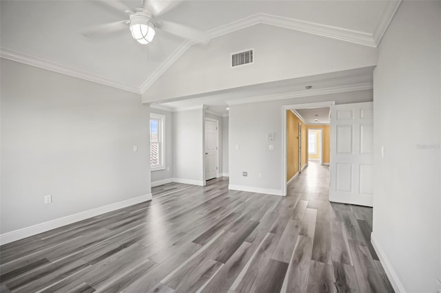 spare room featuring dark wood-style flooring, a ceiling fan, visible vents, and lofted ceiling